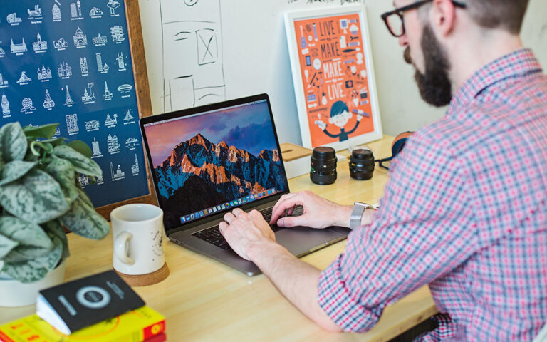 Man at desk using MacBook Pro